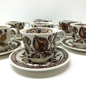 Seven vintage Jacobean Ironstone cups and saucers.